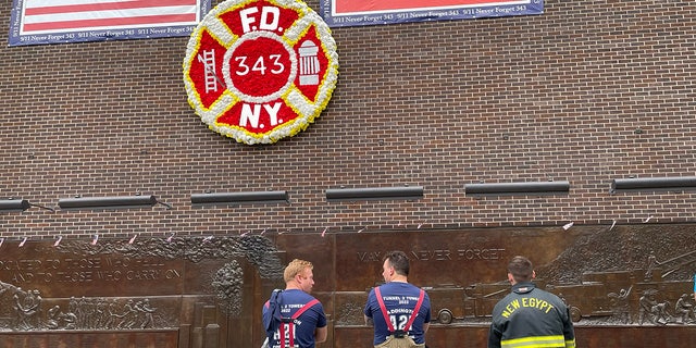 Firefighters paused to reflect at the FDNY memorial wall in Lower Manhattan following the Tunnel to Towers annual 5K on Sunday, Sept. 25, 2022.