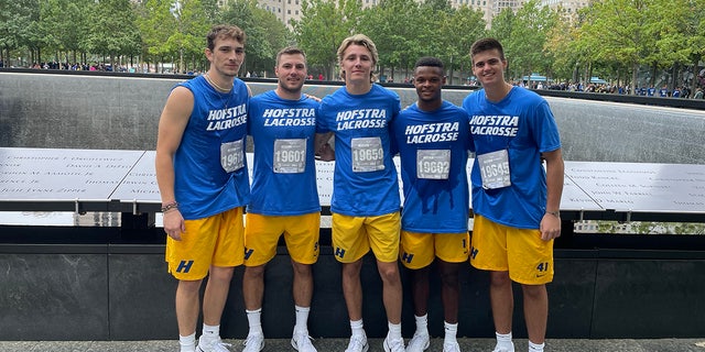 Hofstra University lacrosse player Teigue Norman (far left) and teammates visit the 9/11 memorial pools after completing the Tunnel to Towers annual 5K in New York City on Sunday, Sept. 25, 2022.