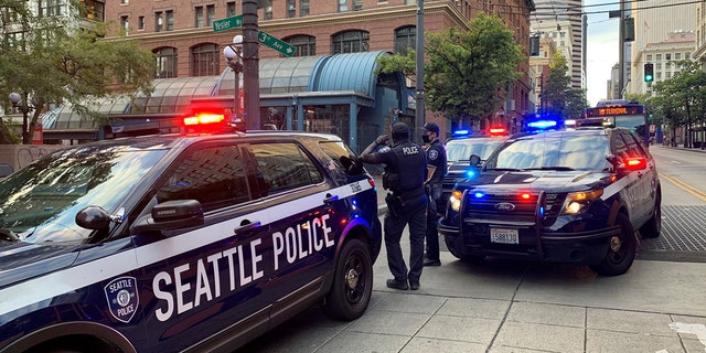 Seattle police respond to a shooting incident in the 200 block of Yesler Way in the Pioneer Square neighborhood, Sept. 1, 2021.