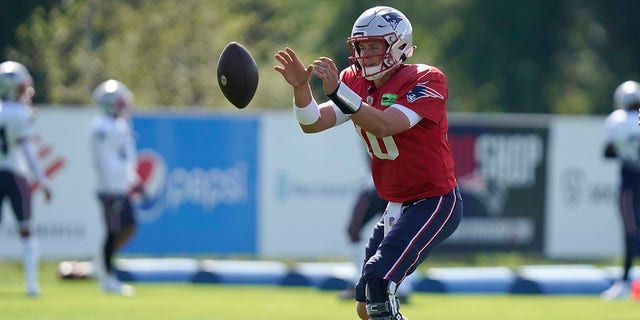 New England Patriots quarterback Mac Jones warms up during an NFL football joint practice with the Carolina Panthers, Tuesday, Aug. 16, 2022, in Foxborough, Mass. 