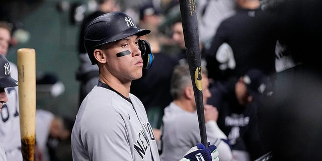 The New York Yankees' Aaron Judge stands in the dugout ahead of Game 1 of baseball's American League Championship Series between the Houston Astros and New York Yankees Oct. 19, 2022, in Houston.