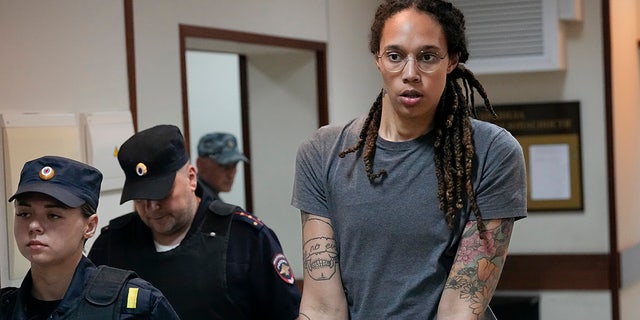 WNBA star and two-time Olympic gold medalist Brittney Griner is escorted from a courtroom after a hearing in Khimki just outside Moscow, Russia, Aug. 4, 2022. 