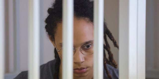 U.S. basketball player Brittney Griner, who was detained at Moscow's Sheremetyevo airport and later charged with illegal possession of cannabis, sits inside a defendants' cage during the reading of the court's verdict in Khimki outside Moscow, Russia, Aug. 4, 2022.