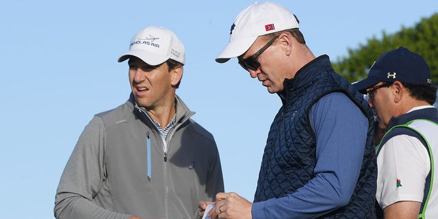 Former NFL players Peyton Manning and Eli Manning look on from the 11th tee during the second round of the AT&amp;T Pebble Beach Pro-Am at Monterey Peninsula Country Club on February 07, 2020 in Pebble Beach, California.