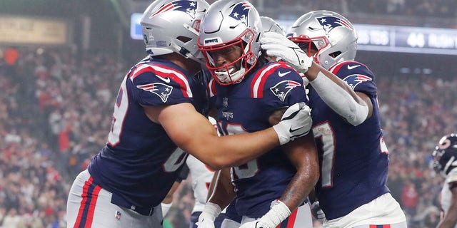 New England Patriots wide receiver Jakobi Meyers, center, is congratulated after his touchdown during the first half of an NFL football game against the Chicago Bears, Monday, Oct. 24, 2022, in Foxborough, Mass.