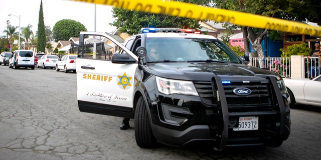 Police work the crime scene where three children were found dead at a home on June 28, 2021, in East Los Angeles.