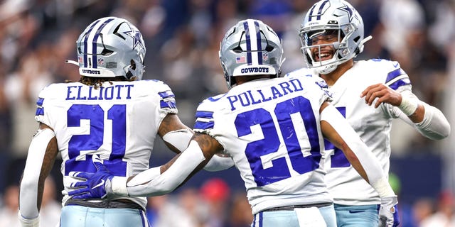 Dak Prescott of the Dallas Cowboys, right, celebrates with Ezekiel Elliott and Tony Pollard after a touchdown against the Detroit Lions during the fourth quarter on Oct. 23, 2022, in Arlington, Texas.