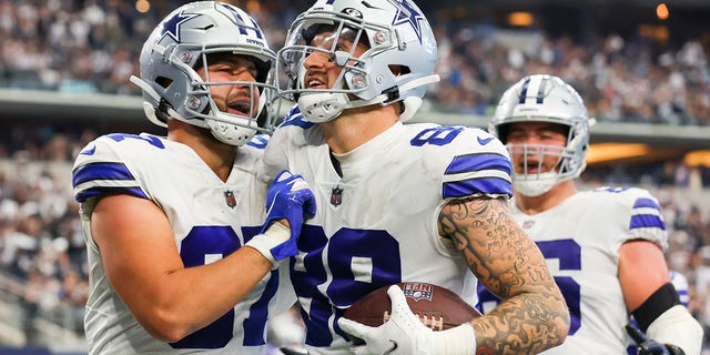 Peyton Hendershot #89 of the Dallas Cowboys is congratulated by Jake Ferguson #87 (L) after scoring a touchdown against the Detroit Lions during the fourth quarter at AT&amp;amp;T Stadium on October 23, 2022 in Arlington, Texas. 