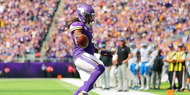Dalvin Cook of the Minnesota Vikings runs the ball in for a touchdown against the Detroit Lions at U.S. Bank Stadium on Sept. 25, 2022, in Minneapolis.