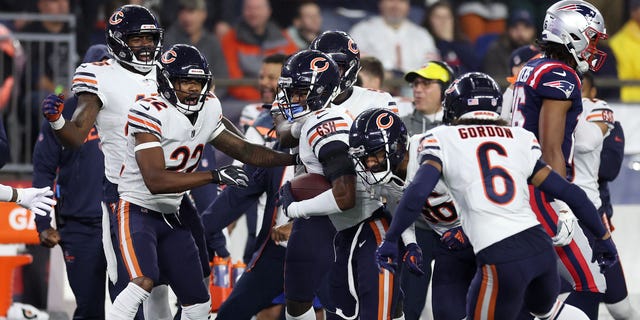 Jaquan Brisker #9 of the Chicago Bears celebrates with teammates after intercepting a pass during the second quarter against the New England Patriots at Gillette Stadium on October 24, 2022 in Foxborough, Massachusetts.