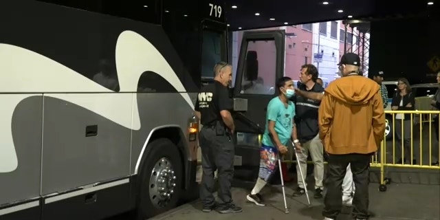 A migrant on crutches and missing a limb disembarks a bus at Port Authority in New York City on Sept. 18, 2022. 