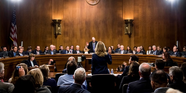 Christine Blasey Ford is sworn in by Senate Judiciary Committee chairman Chuck Grassley, R-Iowa, at the start of her testimony on Capitol Hill in Washington, Sept. 27, 2018. 