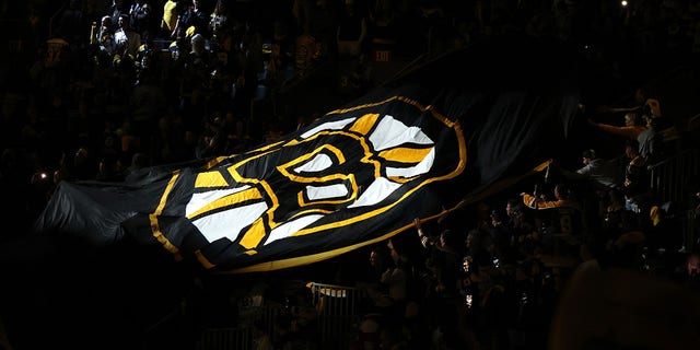 A flag with the Boston Bruins logo is moved by fans before Game 3 of the first round of the Stanley Cup playoffs at TD Garden on May 6, 2022, in Boston.