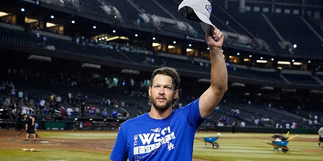 Los Angeles Dodgers starting pitcher Clayton Kershaw waves to Dodgers fans after the team's 4-0 win in a game against the Arizona Diamondbacks in Phoenix Sept. 13, 2022.