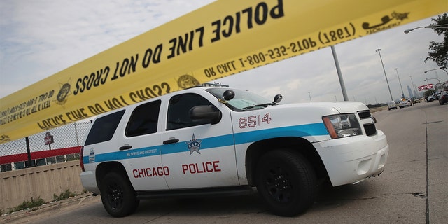  Police investigate the murder of a young man found shot to death in the back seat of a bullet-riddled car on June 30, 2017 in Chicago, Illinois.