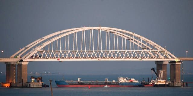 A ship under the Kerch bridge blocks the passage to the Kerch Strait near Kerch, Crimea, Sunday, Nov. 25, 2018.