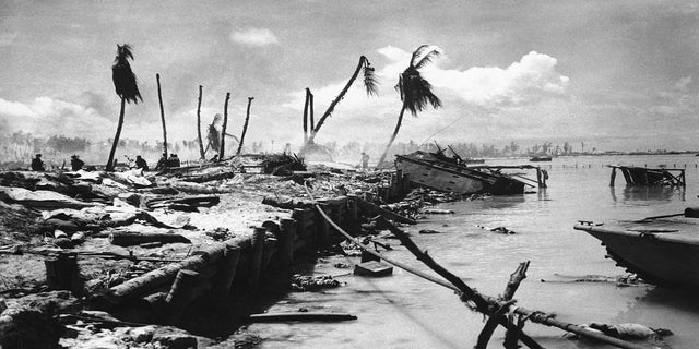 In this November 1943 file photo, bodies and wrecked amphibious tractors litter a battlefield after U.S. Marines from the 2nd Division forced back the Japanese on Betio island in the Tarawa Atoll, Kiribati. The nation of Kiribati sprawls across both the International Date Line and the equator. 