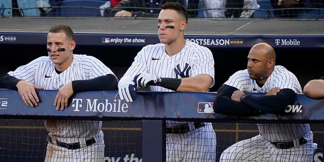 From left, the New York Yankees' Anthony Rizzo, Aaron Judge and Aaron Hicks watch play from the dugout during the tenth inning of Game 2 of an American League Division Series against the Cleveland Guardians Oct. 14, 2022, in New York. 