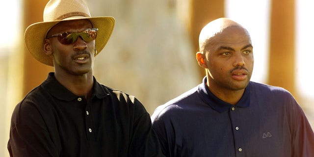 Basketball stars Michael Jordan, left, and Charles Barkley wait to tee off from the 14th tee during the Pro-Am match of the Bob Hope Chrysler Classic.