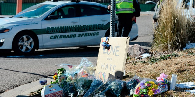 Flowers and a sign reading "love over hate" lay near a gay nightclub in Colorado Springs, Colo., Sunday, Nov. 20, 2022 where a shooting occurred late Saturday night. 