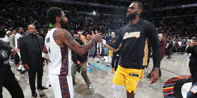 Kyrie Irving of the Brooklyn Nets and LeBron James of the Los Angeles Lakers high-five after a game on Jan. 23, 2020, at Barclays Center in New York.