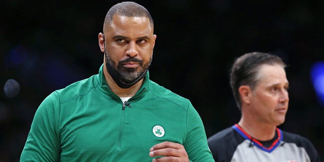 Celtics head coach Ime Udoka, left, did not agree with a referee in the second quarter. The Boston Celtics hosted the Golden State Warriors for Game Six of the NBA Finals at the TD Garden in Boston on June 17, 2022. 