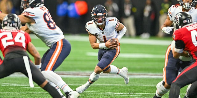 Chicago quarterback Justin Fields (1) runs the ball during the NFL game between the Chicago Bears and the Atlanta Falcons on November 20th, 2022 at Mercedes-Benz Stadium in Atlanta, GA.  