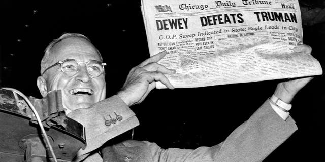 President Harry Truman holds up a copy of the Chicago Daily Tribune declaring his defeat to Thomas Dewey in the presidential election, in St. Louis, Missouri, November 1948. 