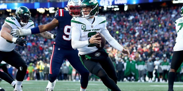 Zach Wilson, #2 of the New York Jets, scrambles against the New England Patriots during the third quarter at Gillette Stadium on Nov. 20, 2022 in Foxborough, Massachusetts. 