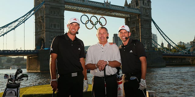 Dustin Johnson of the USA, Mark King, CEO of TaylorMade Golf, and Sergio Garcia of Spain pose for photos after hitting balls into the Thames River during the Adidas Paints the Town Red Adidas London Golf Challenge at the Tower Bridge on July 23, 2012, in London, England.  