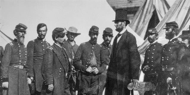 (Original Caption) President Abraham Lincoln with General George B. McClellan at his headquarters at Antietam, Oct. 3, 1862. From left: General George W. Morell, Colonel Alexander S. Webb, General McClellan, scout Adams, Dr. Jonathan Letterman, unidentified officer, President Lincoln, Colonel Henry Hunt, General Fitz, John Porter, unidentified officer.