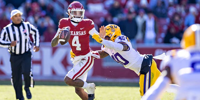 Arkansas' Malik Hornsby is tackled by Harold Perkins Jr. of the LSU Tigers at Donald W. Reynolds Razorback Stadium on Nov. 12, 2022, in Fayetteville.
