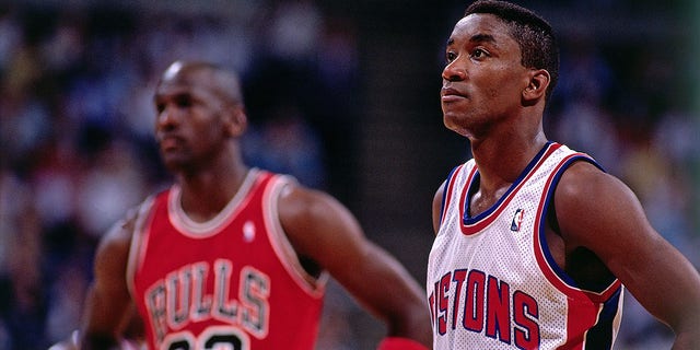 Isiah Thomas, #11 of the Detroit Pistons, takes some time to catch his breath with Michael Jordan, #23 of the Chicago Bulls, during a break in the action during an NBA game at The Palace circa 1989 in Auburn Hills, Michigan. 