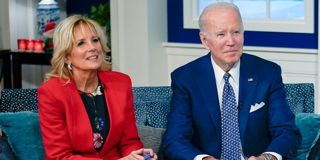 President Biden and first lady Jill Biden speak with the NORAD Tracks Santa Operations Center at Peterson Air Force Base, Colo., via teleconference in the South Court Auditorium on the White House campus in Washington Dec. 24, 2021.