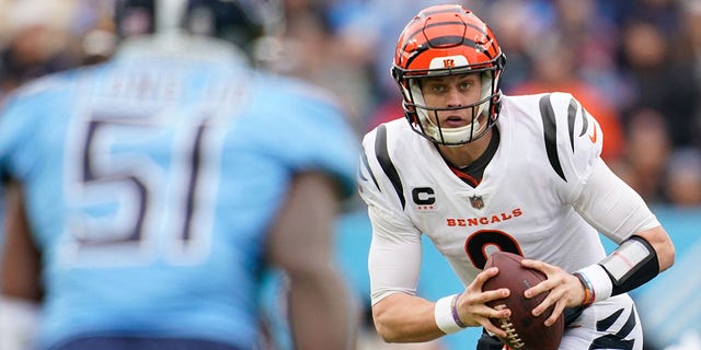 Cincinnati Bengals quarterback Joe Burrow, #9, looks for an opening to pass as they face the Tennessee Titans during the second quarter at Nissan Stadium in Nashville, Tennessee, Nov. 27, 2022.