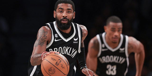 Brooklyn Nets guard Kyrie Irving, #11, dribbles up court against the Chicago Bulls during the first half at Barclays Center in Brooklyn, New York, Nov. 1, 2022.