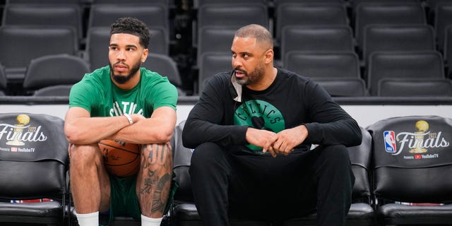 Jayson Tatum, left, of the Boston Celtics and head coach Ime Udoka sit on the bench during a 2022 NBA Finals practice and media availability June 9, 2022, at the TD Garden in Boston. 
