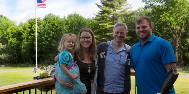 Travis Mills and his family with Gary Sinise during a visit. 