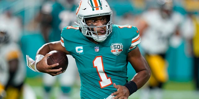 Miami Dolphins quarterback Tua Tagovailoa runs the ball during the first half of a game against the Pittsburgh Steelers Oct. 23, 2022, in Miami Gardens, Fla.