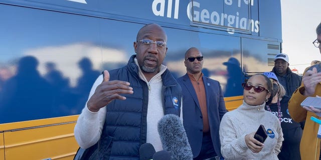 Democratic Georgia Sen. Raphael Warnock speaks with members of the media following a campaign rally in Conyers, Georgia on November 21, 2022.