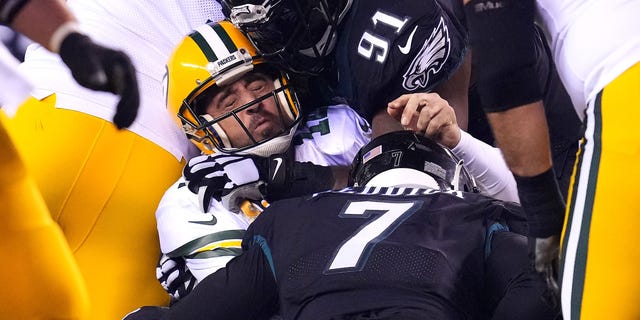 Aaron Rodgers #12 of the Green Bay Packers is sacked by Brandon Graham #55 of the Philadelphia Eagles during the third quarter at Lincoln Financial Field on November 27, 2022, in Philadelphia, Pennsylvania.