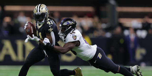 Alvin Kamara #41 of the New Orleans Saints runs the ball and is tackled by Roquan Smith #18 of the Baltimore Ravens during the second quarter at Caesars Superdome on November 07, 2022 in New Orleans, Louisiana.
