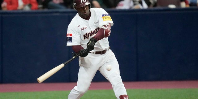 Former baseball outfielder Yasiel Puig, of Kiwoom Heroes, hits a ball during the opening game of the 2022 regular season for the Korea Baseball Organization in Seoul, South Korea, April 2, 2022. Authorities say Puig will plead guilty to lying to federal agents investigating an illegal sports gambling operation. The U.S. Department of Justice announced Monday, Nov. 14, 2022, that Puig acknowledged in unsealed court documents that he denied betting on the operation when in fact he made hundreds of bets in 2019.