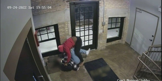 The suspect is seen on video pushing the woman to the ground as the pair fought.