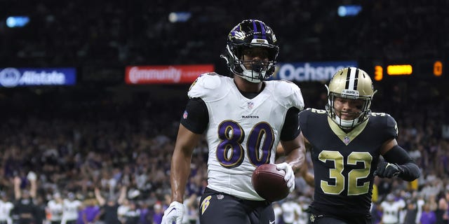 Isaiah Likely #80 of the Baltimore Ravens catches a pass for a touchdown against Marcus Maye #6 and Tyrann Mathieu #32 of the New Orleans Saints during the first quarter at Caesars Superdome on November 07, 2022 in New Orleans, Louisiana.