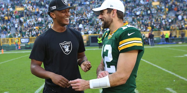 Green Bay Packers quarterback Aaron Rodgers (12) talks with Oakland Raiders quarterback DeShone Kizer after a game at Lambeau Field Oct. 20, 2019, in Green Bay, Wis. 