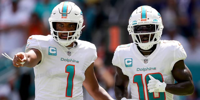 Tua Tagovailoa, #1, and Tyreek Hill, #10 of the Miami Dolphins, in action during the first half of the game against the Buffalo Bills at Hard Rock Stadium on Sept. 25, 2022 in Miami Gardens, Florida.