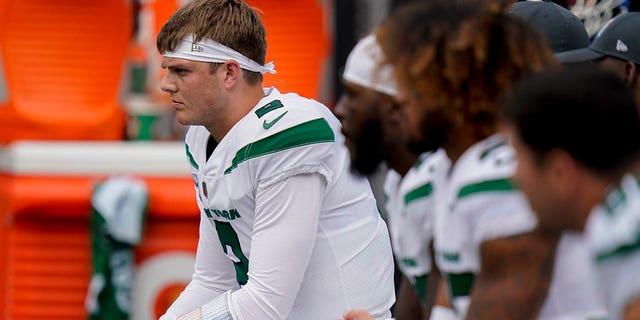 FILE - New York Jets quarterback Zach Wilson sits on the bench during the first half of an NFL football game against the Tennessee Titans, Sunday, Oct. 3, 2021, in East Rutherford.