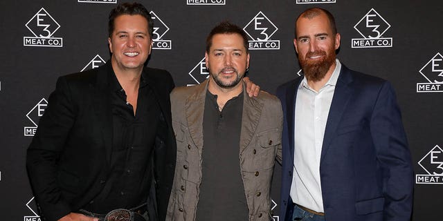 Luke Bryan (at left), Jason Aldean (center), and Adam LaRoche attend the grand opening of E3 Chophouse Nashville on Nov. 20, 2019 in Nashville, Tennessee. Bryan and LaRoche appeared on "Fox and Friends Weekend" on Sunday to discuss their efforts to help America's veterans. 