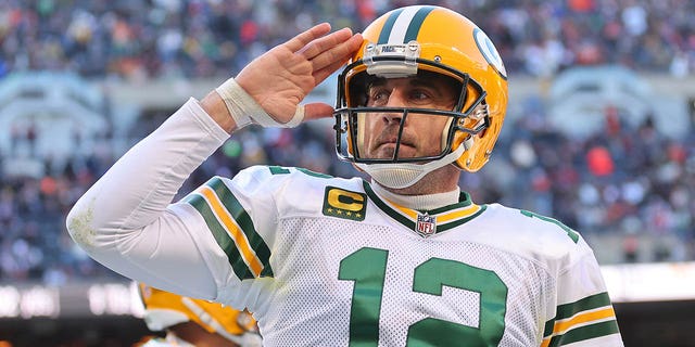 Aaron Rodgers, #12 of the Green Bay Packers, celebrates after a successful two-point conversion against the Chicago Bears during the fourth quarter at Soldier Field on December 4, 2022, in Chicago, Illinois. 